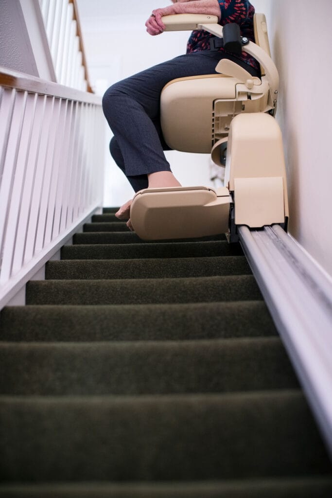 Stair lift used by elderly homeowner