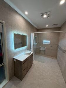 Photo of an NDIS renovated bathroom by Restore Home Modifications. The shower and sink are easy to access.